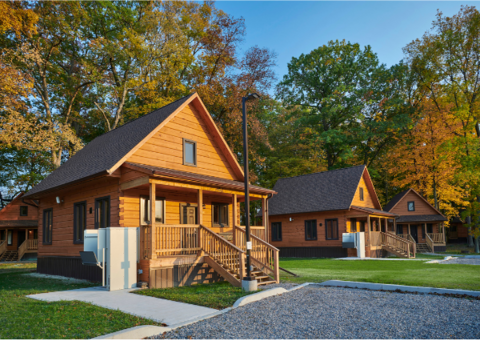 Chiefswood Park log cabin surrounded by trees.