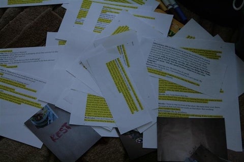 Disorganized pages of highlighted transcripts and printed out images of PSWs completing the body mapping activity.