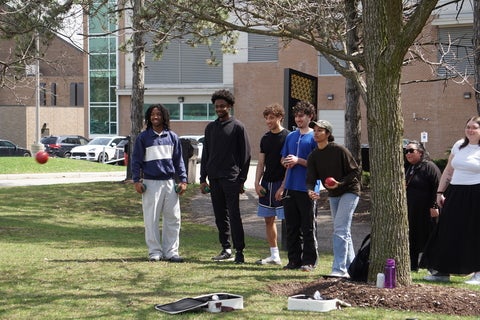 Students playing a game of Bocce.