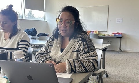 Dr. Kimberly Lopez working on her laptop.