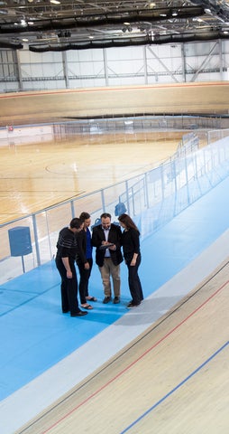 Professor and three grad students conducting research in a cycling velodrome.