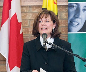 Sherry Dupuis speaking at microphone