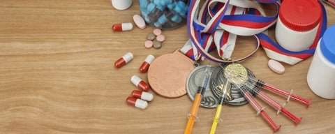 Sports medals admist pharmacy tablets and syringes.