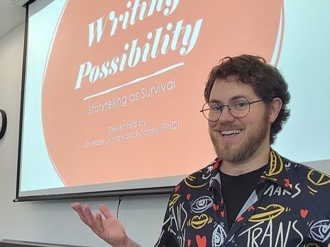 Dr. Markus Harwood-Jones presenting a slideshow for the Writing Possibility event.