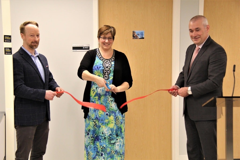 Dr. Troy Glover, Sandy Heise, and Dean James Rush cut the ceremonial ribbon