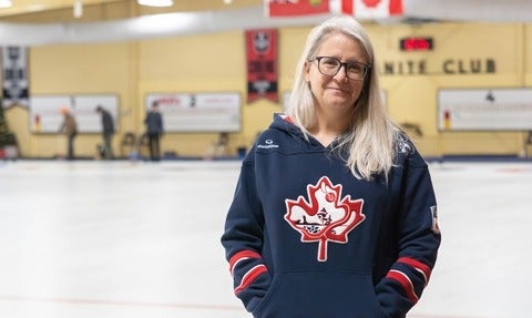 Heather Mair stands beside curling sheets at Waterloo's Granite Curling Club.