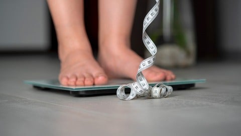 A person checking their weight and height.