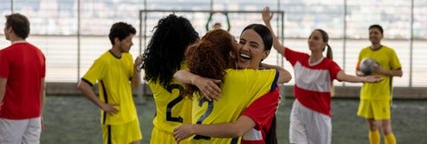 Students celebrating during a soccer game.