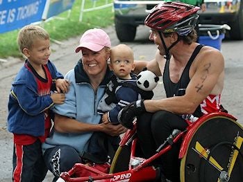 Chris Bourne with wife and sons after triathlon race