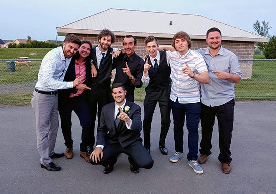 Joe standing with a group of his gaming friends at a wedding.