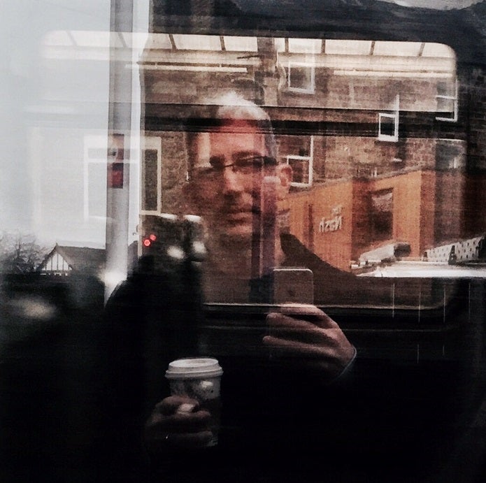 Brett Lashua selfie reflection on a bus window.