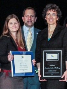 Margo Hilbrecht holding award