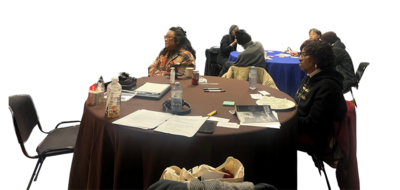 Participants and Dr. Kimberly Lopez watching Shelly Grace speak.
