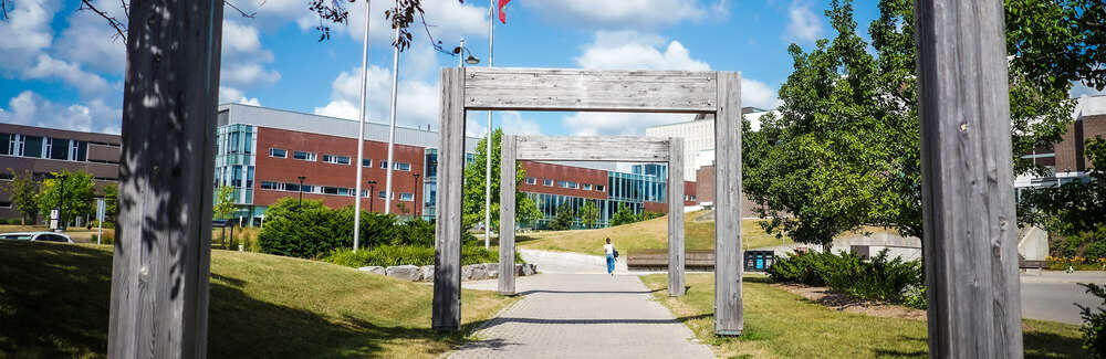 wood arches at campus entrance