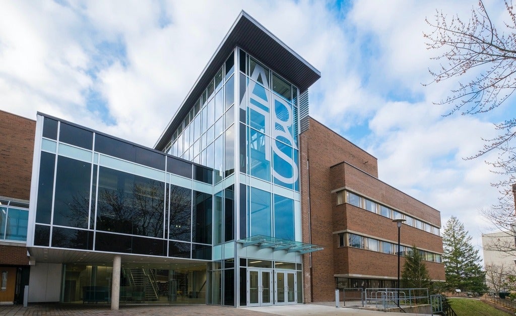The Arts building on UWaterloo campus, a glass tower with ARTS written on it.
