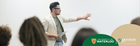 Teacher in front of a class pointing at a white board