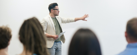 man in front of a white board