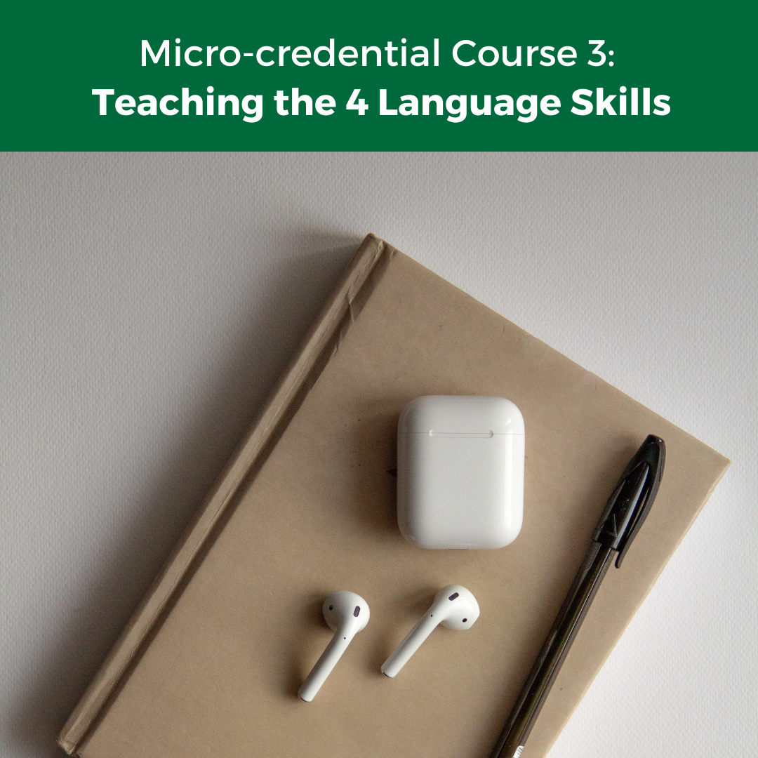 Closed notebook with earphones and pencil on top