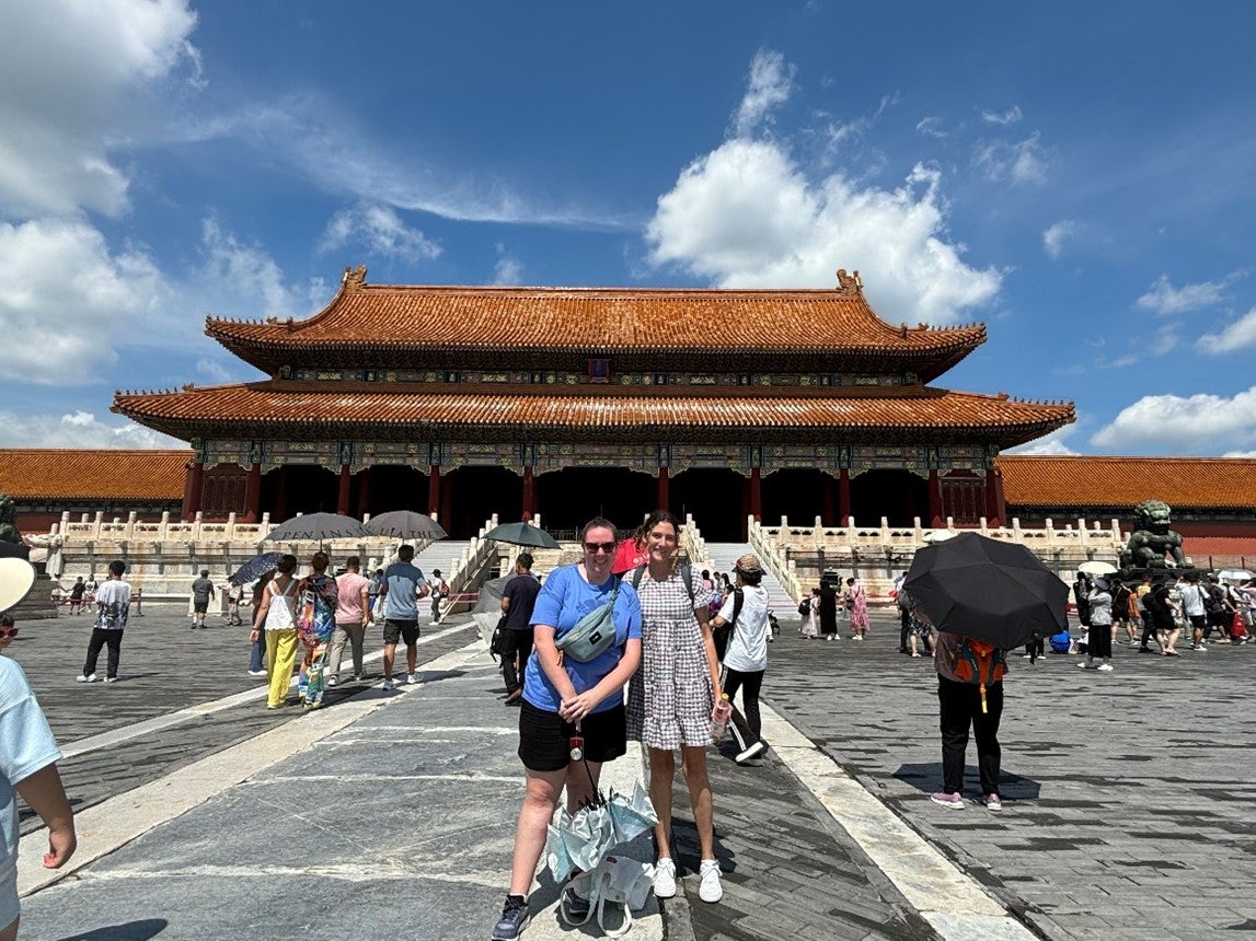 two people in front of a traditional chinese building