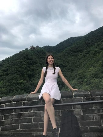 person sitting on a stone wall