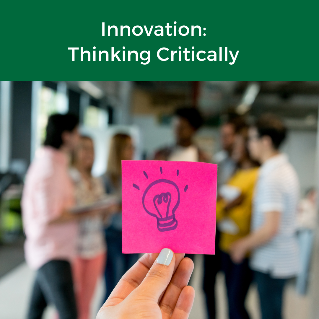 Person holding a small note with a hand‑drawn light bulb, symbolizing a new idea