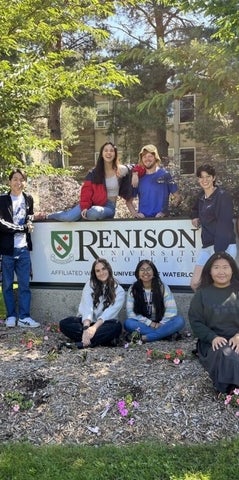 Dons gathered around the Renison sign