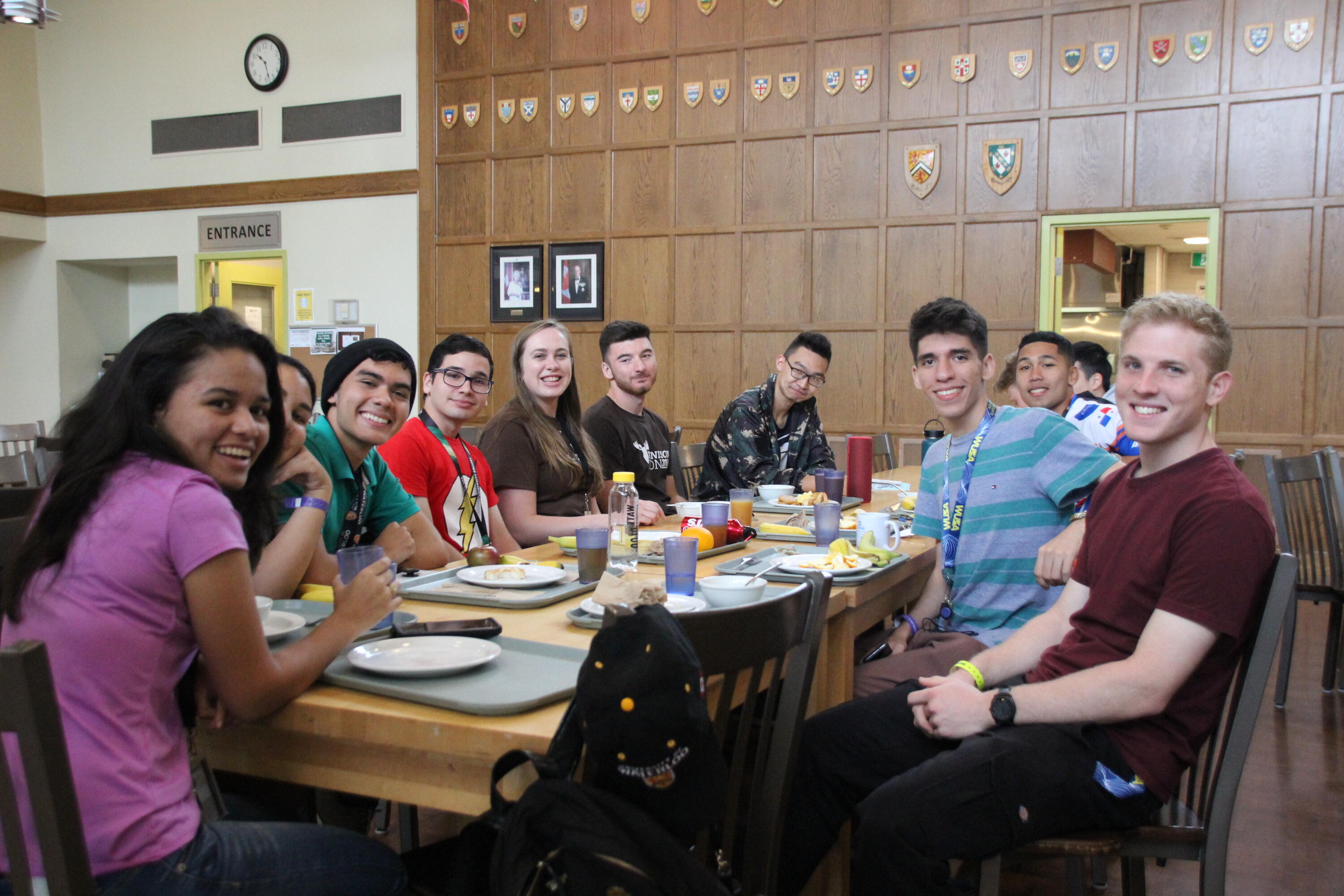 group of students at table eating and smiling
