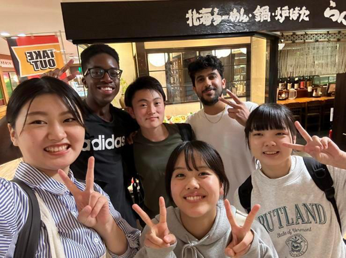 student posing with exchange friends 