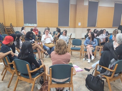 People sitting in a circle and talking 