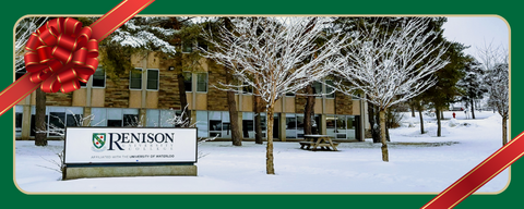 Renison sign with snow around. A green frame with red bow is around the image. 