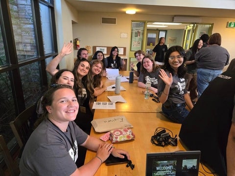 Students sitting around a table in the Renison cafeteria. 