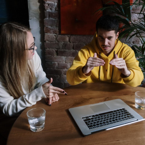 Two people talking using American Sign Language