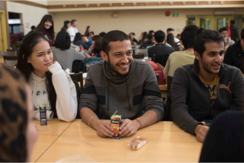 Three students sitting in the Renison cafeteria. 