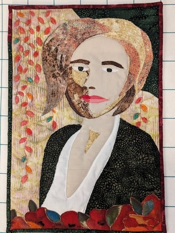 A quilt made to look like a figure. 
