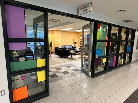 Entrance to the Link Inclusion Lounge. The windows are painted with colours, and the doors are spread wide!