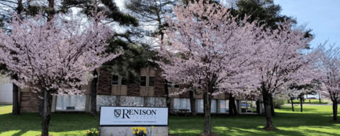 Renison University College surrounded by blooming cherry blossom trees in Spring.