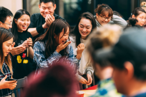 A crowd of students laughing. 