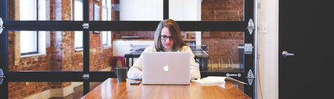 women at a desk with a laptop