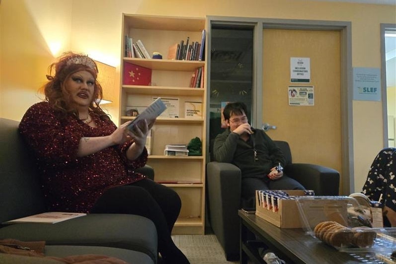 two people in a lounge reading and talking