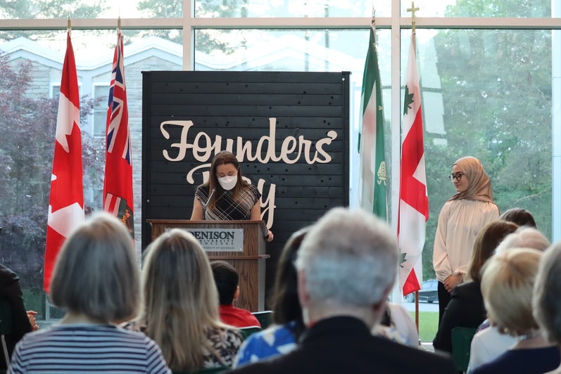 Person at podium in the atrium presents award. 