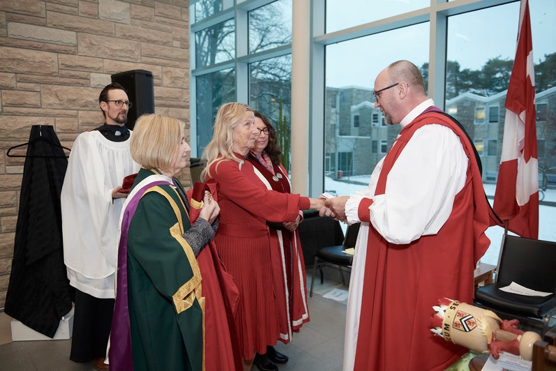 Bishop Todd Townshend holds Jodey's hands during the formal installation ceremony. 
