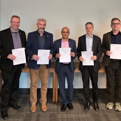 Former UWaterloo president Vivek Goel stands between the four AFIW presidents