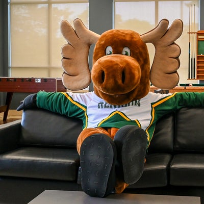 Reni Moose sitting on a couch