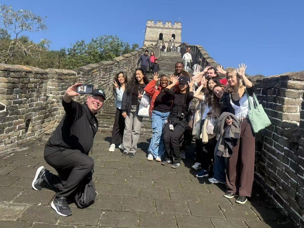 Marc Jerry, Renison President, takes a selfie with students on the Great Wall of China during a recent trip. 