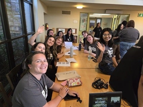 Students sitting around a table in the Renison cafeteria. 