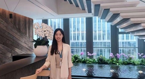 Image of Ella Meng in front of an indoor pond
