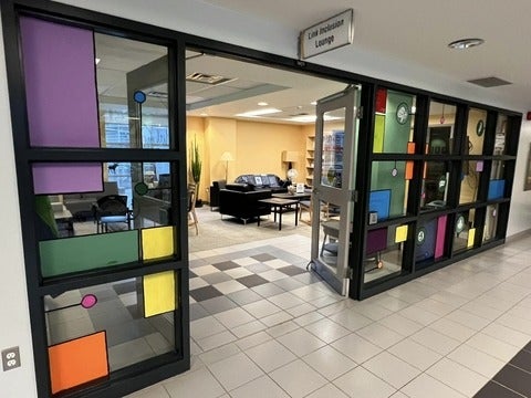 Entrance to the Link Inclusion Lounge. The windows are painted with colours, and the doors are spread wide!