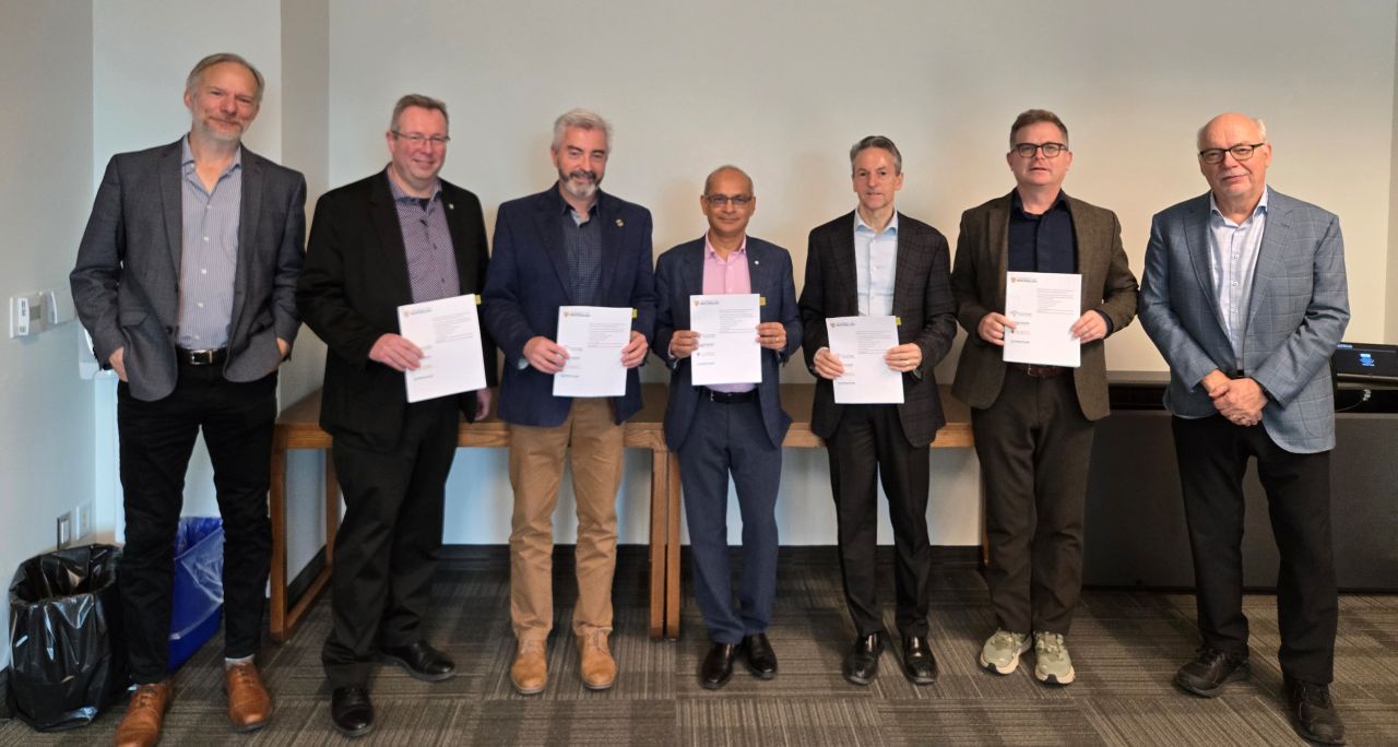 Former UWaterloo president Vivek Goel stands between the four AFIW presidents