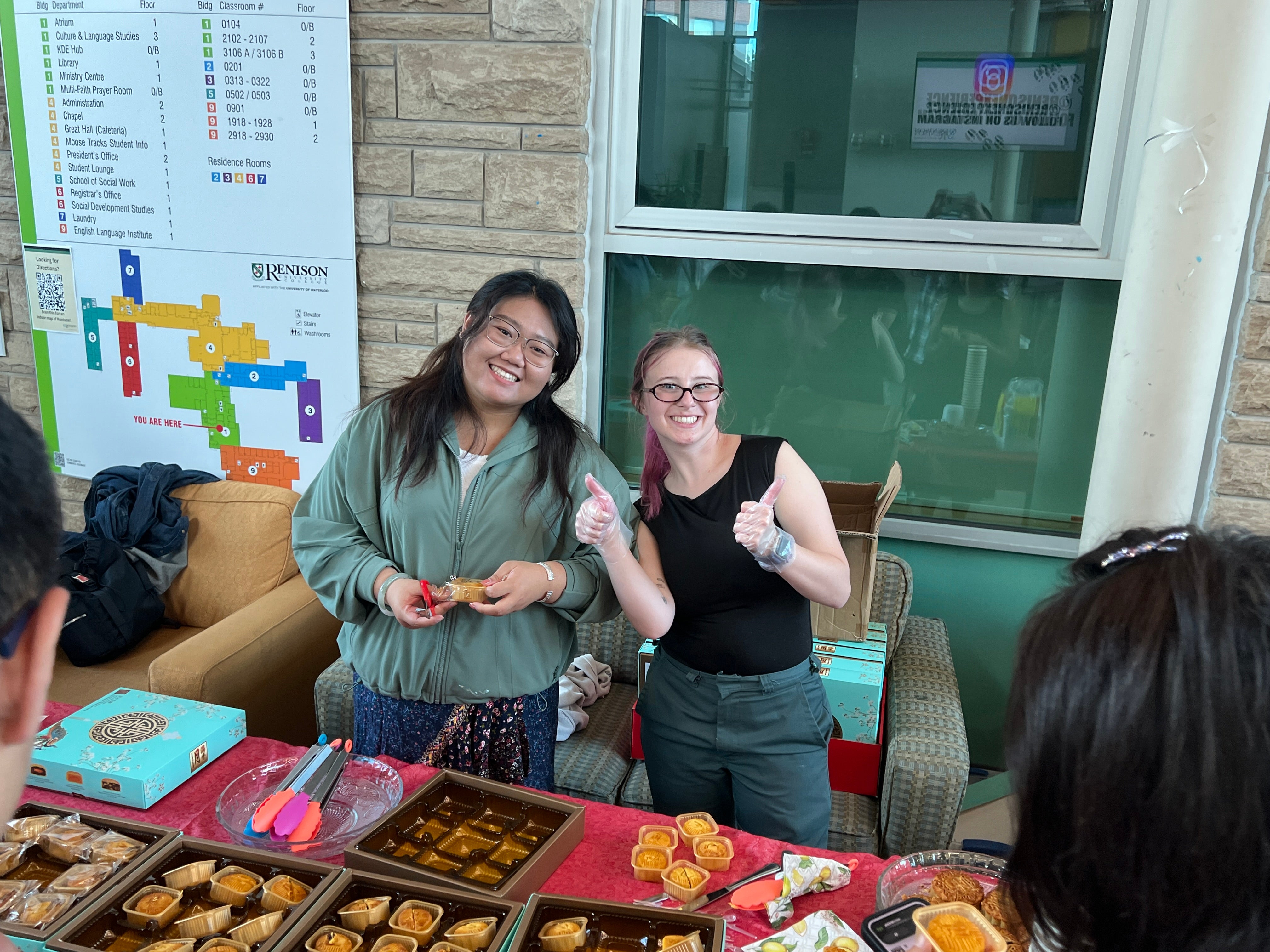 two people behind a booth with Chinese treats