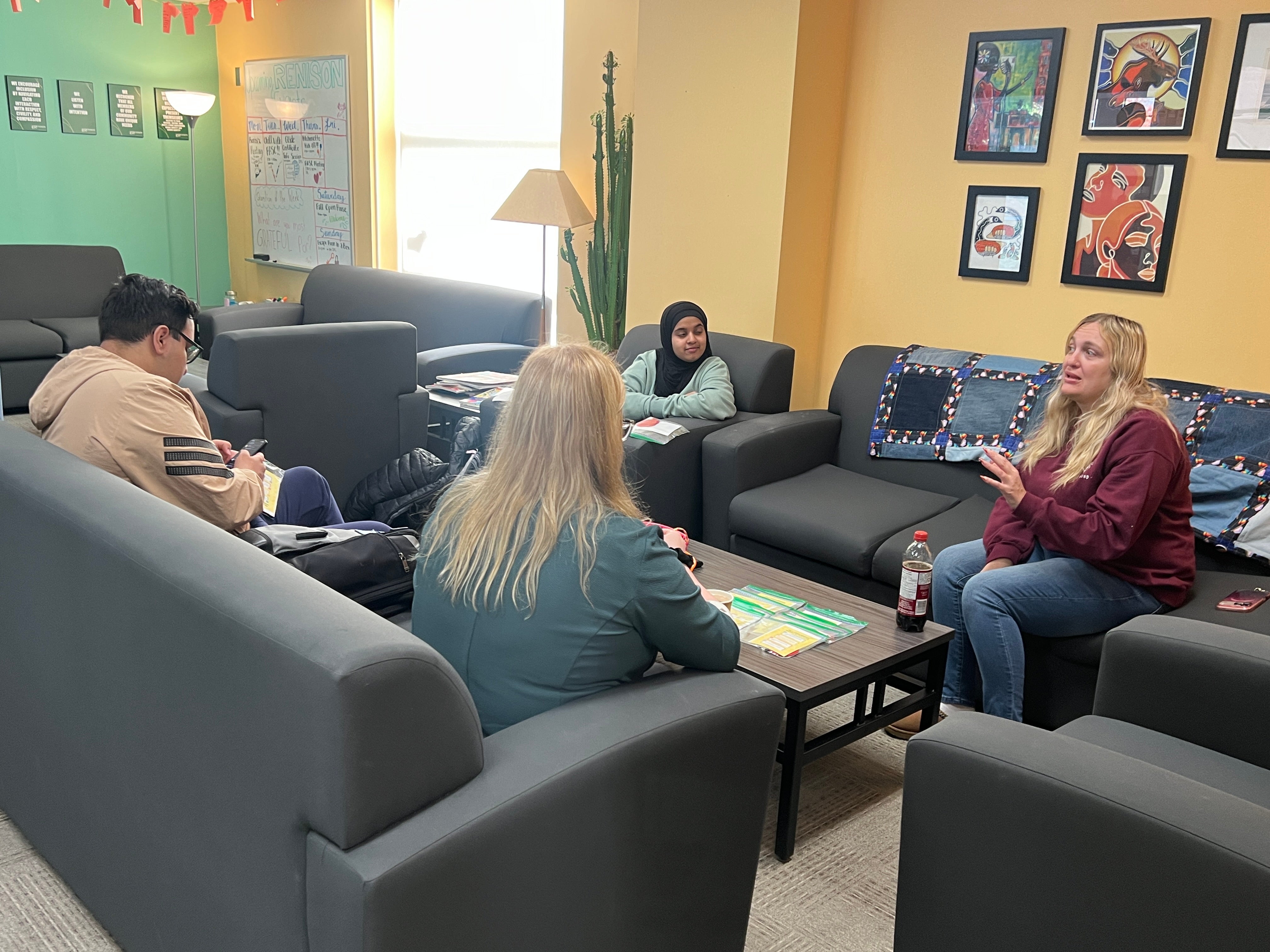 Four people sitting in a lounge